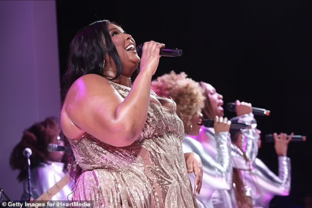 Lizzo flaunts her gorgeous curves in a VERY racy fringed mini-dress as she takes to the stage at a swanky VIP event in Cannes